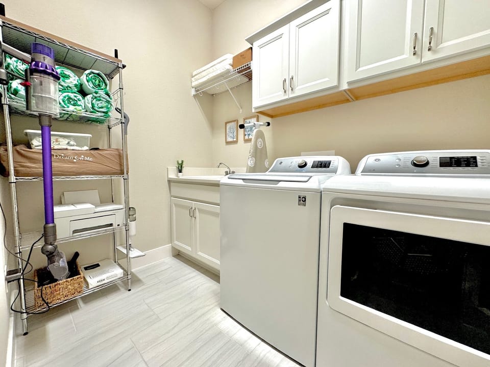 … leads to the laundry room featuring a washer and dryer, as well as pool towels, children’s items and a printer that you are welcome to use. 