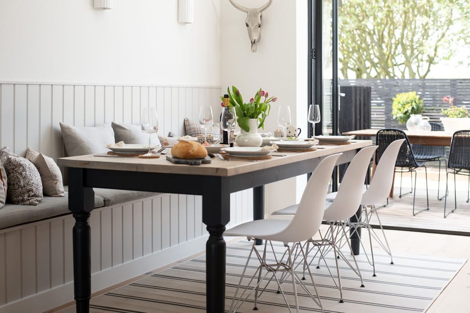 Tide's Watch - large wooden dining table with chairs and bench seating sitting 6-8 guests