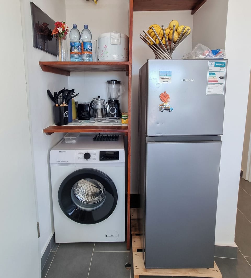 Kitchen well stocked with fridge, microwave, dish washer, over, stovetop, kettle