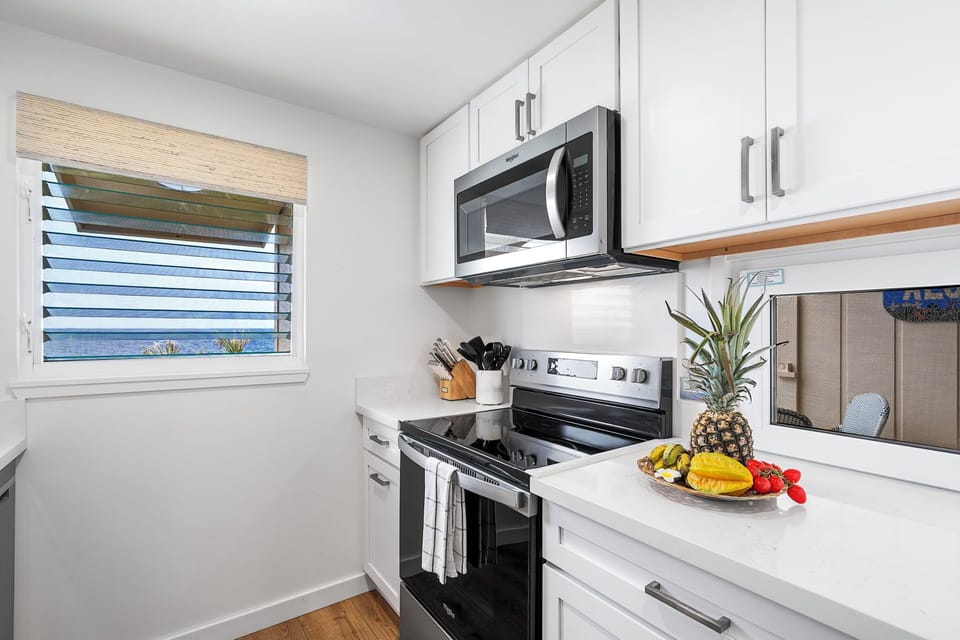 Prepare island-inspired meals in the remodeled kitchen with quartz counters and stainless steel appliances.