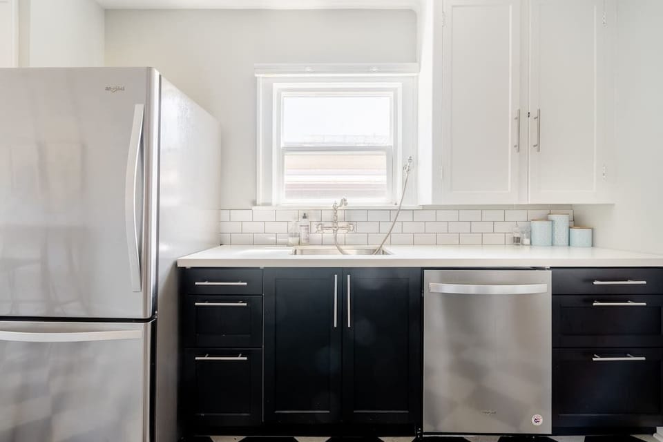 Main kitchen with dishwasher and refrigerator.