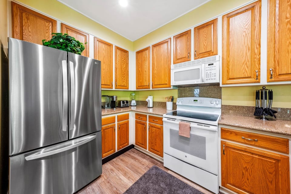 Step into this modern kitchen with sleek appliances and warm wood accents.