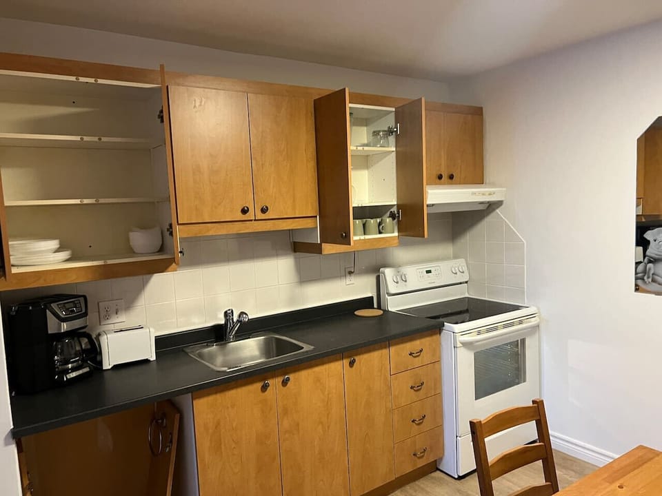 Fully equipped kitchen with modern appliances including oven, stove, and microwave. Everything needed for home-cooked meals during your stay.