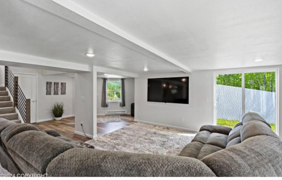 Relax in comfort with cozy seating for seven in this spacious living room.