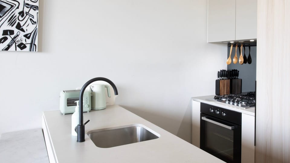 Modern kitchen sink area, fully equipped for your stay.