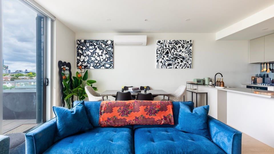Spacious open-plan lounge with vibrant accents and natural light.