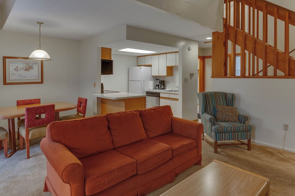 Open-concept living area with warm wood tones, a fireplace, and comfortable seating—perfect for relaxing after a day outdoors.