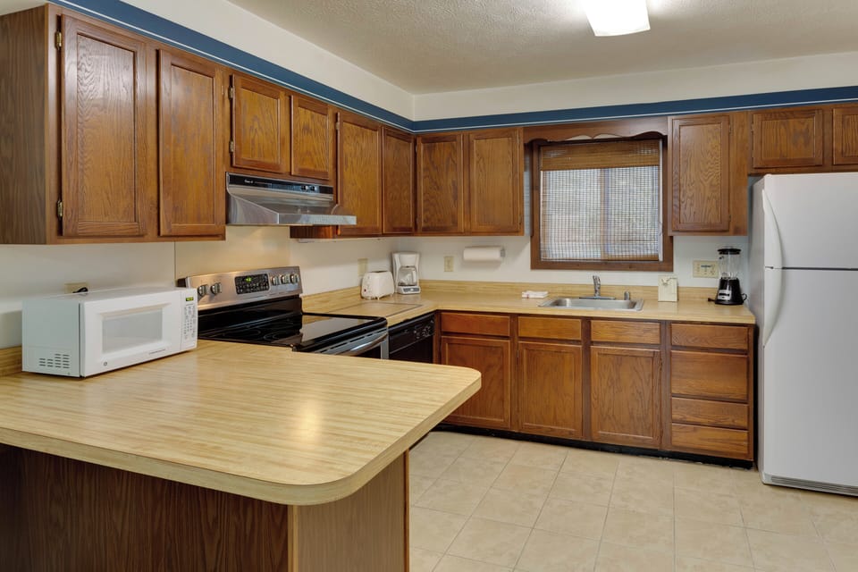 Fully equipped kitchen with ample counter space and modern appliances—ideal for cooking meals together.