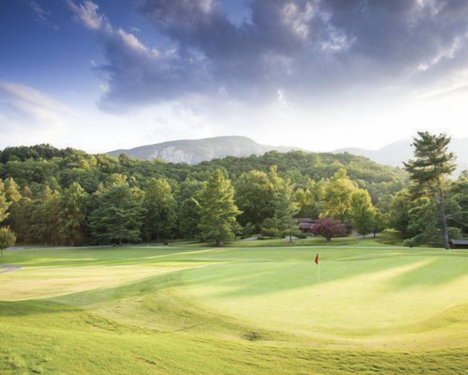 Golf course with serene mountain backdrop