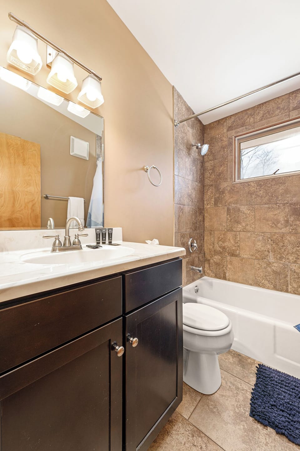 Full bathroom w/ vanity, sink & shower-tub combo for easy routines.