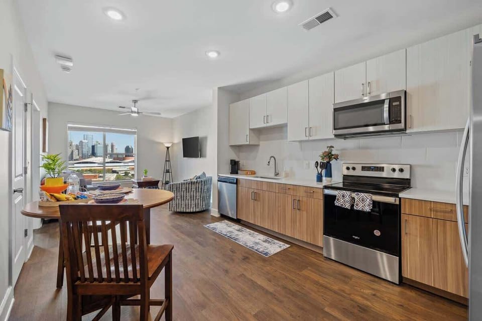 - Modern kitchen with stainless appliances and open design for easy cooking
- Cozy dining area with bright window views perfect for relaxed meals
- Spacious layout near downtown hotspots ideal for vacation stays
