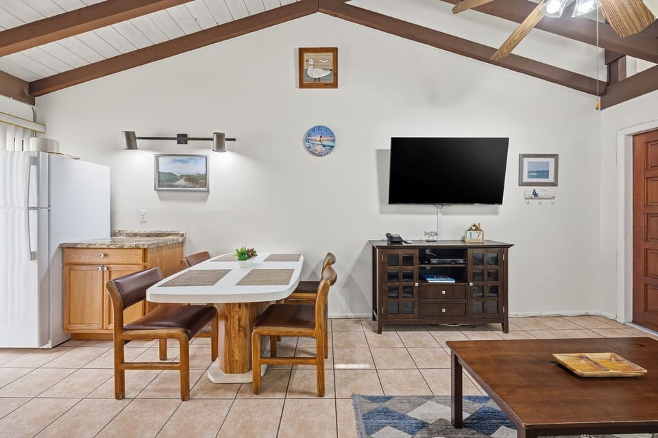 The kitchen and dining area offer ample cabinetry, modern appliances, and a table for enjoying meals together.