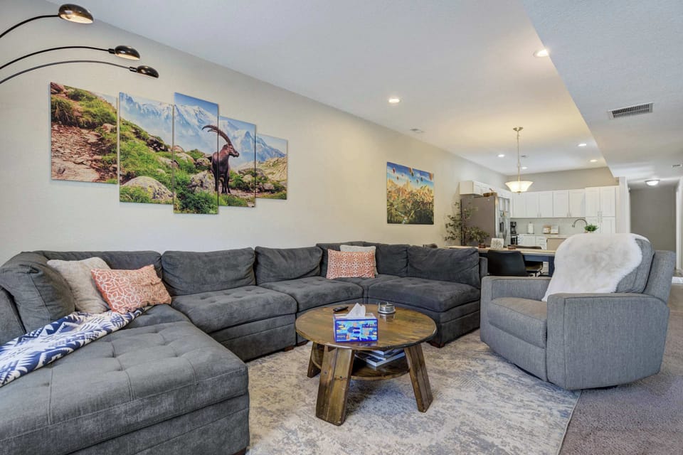The spacious sectional offers plenty of room to kick back and relax, with open sightlines to the kitchen and bold artwork adding personality to the space.








