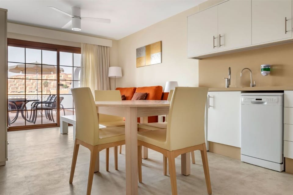 Airy dining area with adjacent kitchen, ideal for family meals.