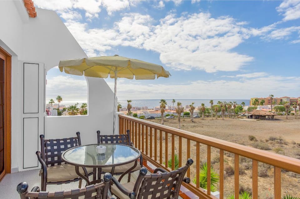 Balcony seating area perfect for outdoor dining and enjoying the scenic horizon.