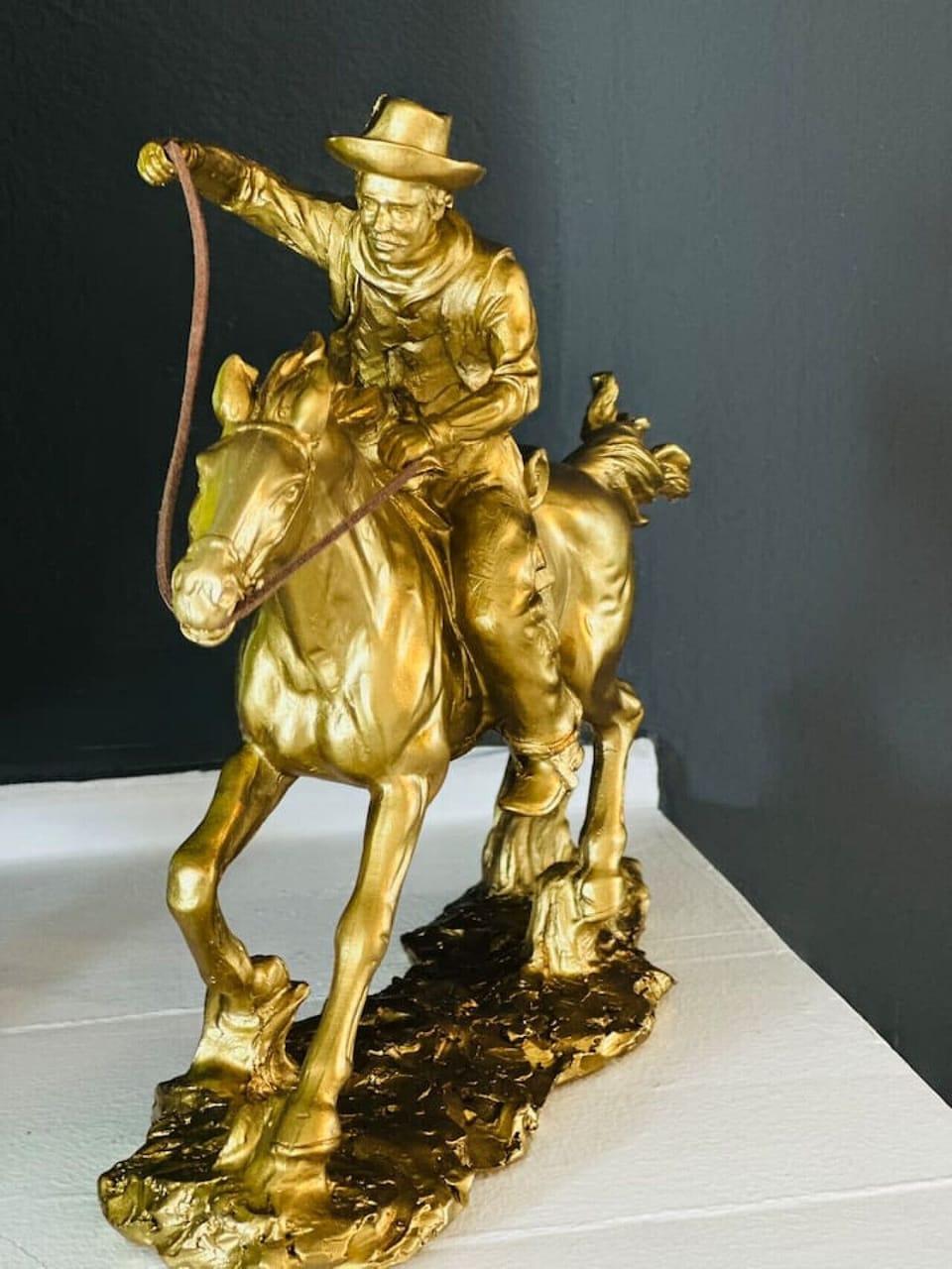 Vintage-style cowboy sculpture adds a touch of character to the mantle.