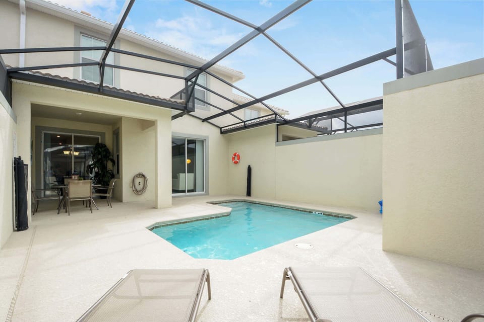 Cool off in your private screened-in pool, perfect for a refreshing swim or lounging under the Florida sun in complete privacy.