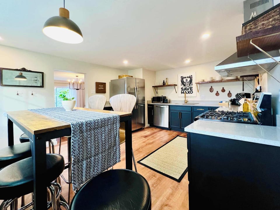 KITCHEN | FIRST FLOOR: This kitchen has bar height seating for six. A highchair (not shown) is stowed away but easily accessible for your use if needed. There's even kid-friendly dinnerware for our youngest guests!