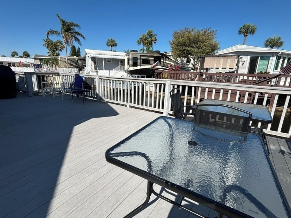 Large deck area overlooking canal.  Deck chairs, table and porch swing.
