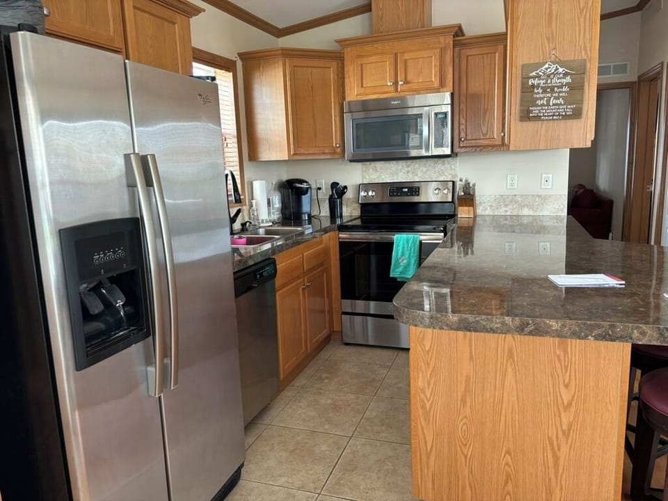 Kitchen with all appliances, dishes and cookware.