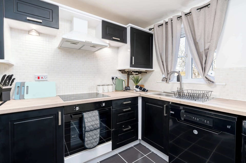 Fully equipped kitchen with ample counter space and all appliances needed for preparing quick meals between jobs or cooking proper dinners after work.