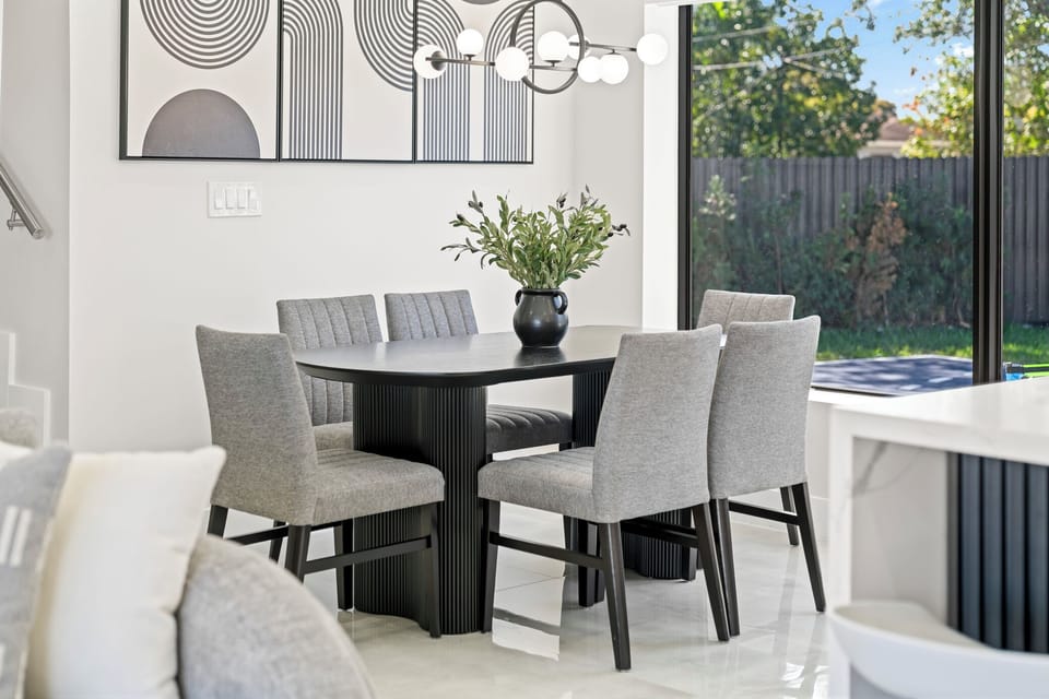 This stylish dining area, adorned in calming gray tones