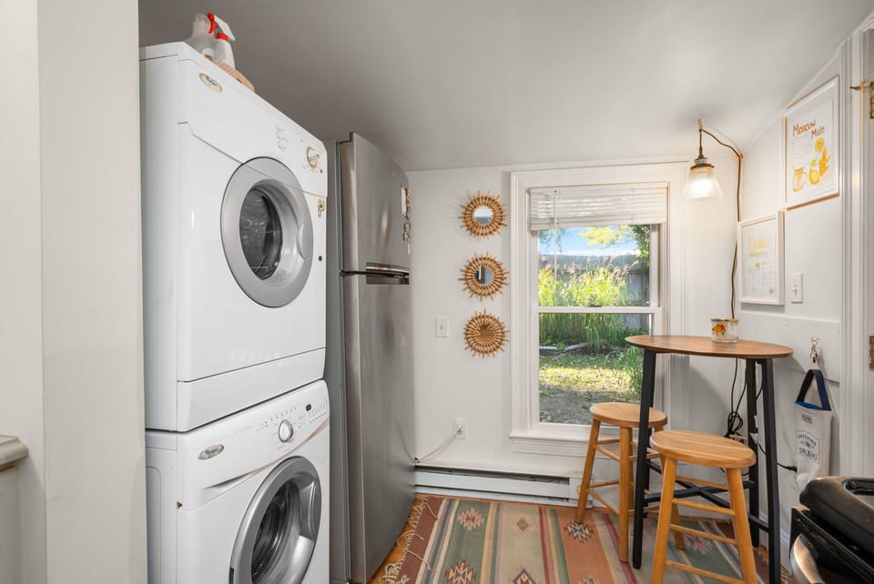 You will find a dining table and in-suite washer/dryer at the back of the kitchen. 