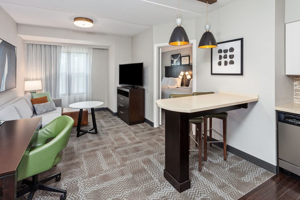 Spacious suite showcasing a living area and kitchenette.