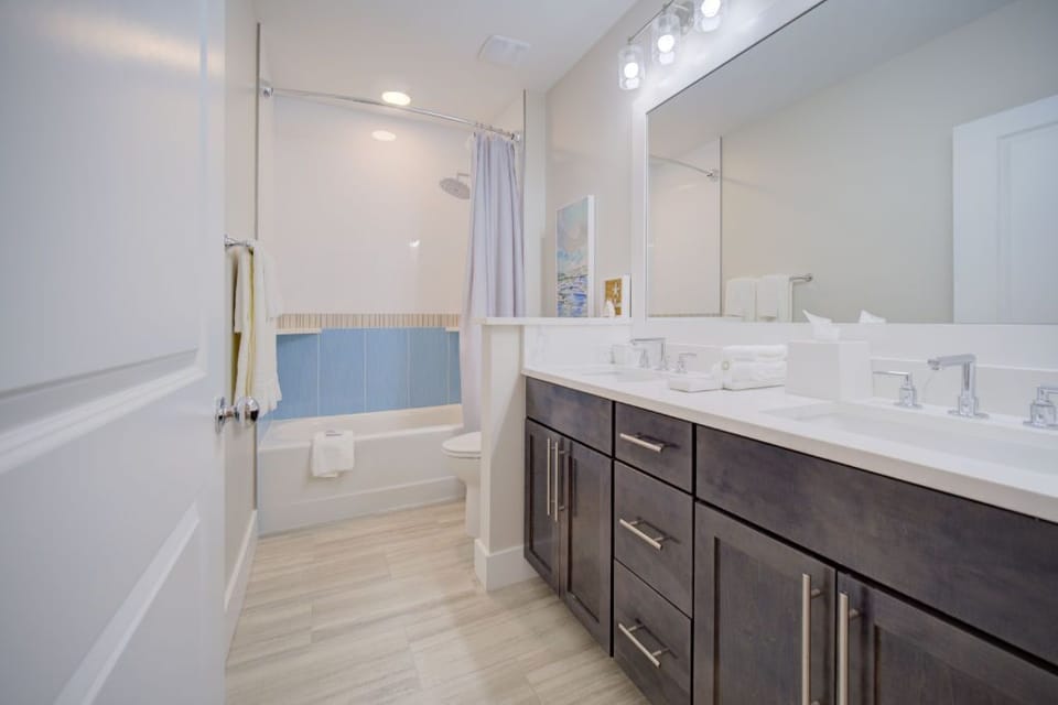 This bathroom combines functionality with style, featuring ample counter space and storage.