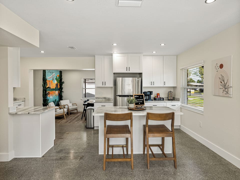 Enjoy meals, morning coffee, or casual chats at the spacious eat-in counter, perfectly set in a bright, open-concept kitchen. With natural light, clean finishes, and comfy seating, it flows seamlessly into the living area—great for entertaining or staying connected.
