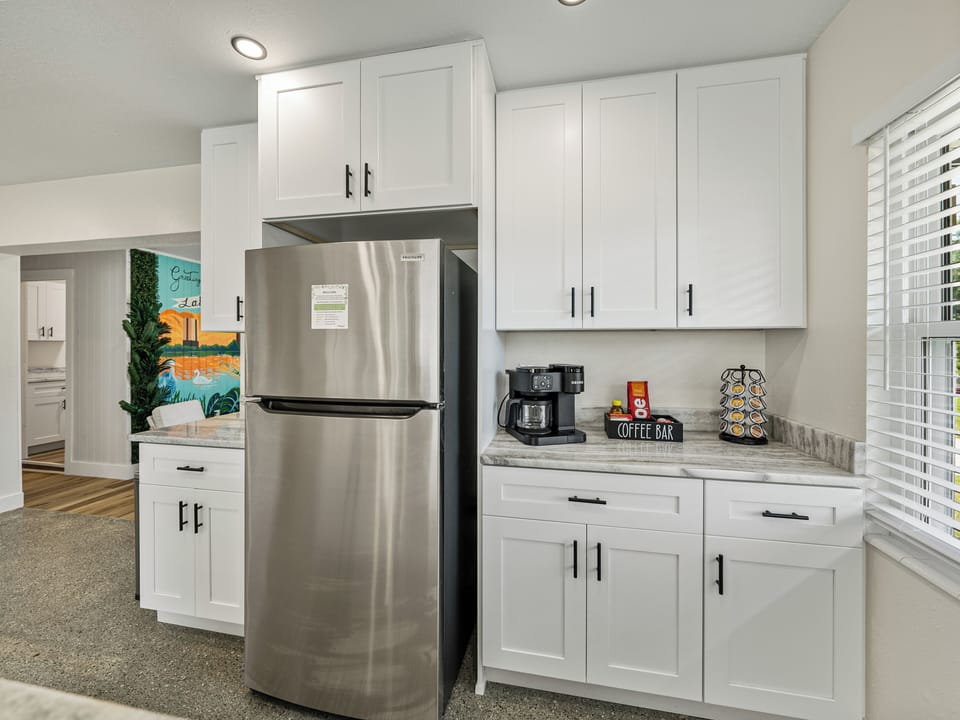 This stylish coffee bar features a dual Keurig system for drip coffee and single-serve cups, offering both hot and cold beverage options. Sleek storage keeps Keurig cups, creamers, and sweeteners organized, blending style and functionality.