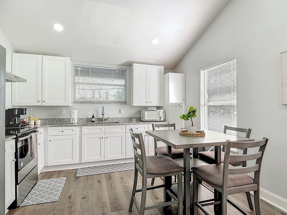 Quaint dining space featuring a cozy high-top table for four—perfect for casual meals, morning coffee, or a relaxed evening in.