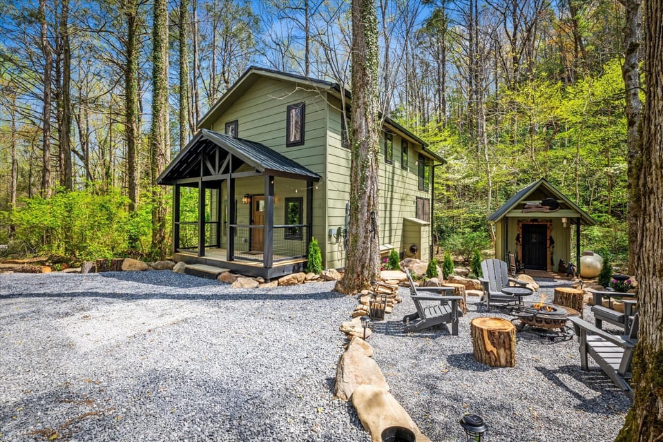 Charming green cabin nestled in nature, perfect for a relaxing getaway.
