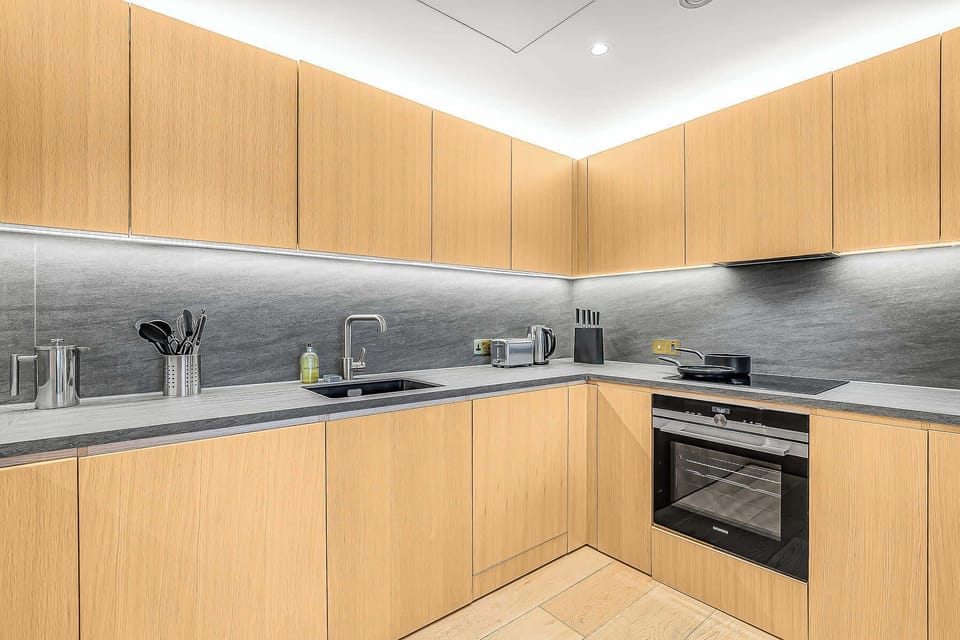 Square-shaped kitchen with a bar countertop that seats 3.