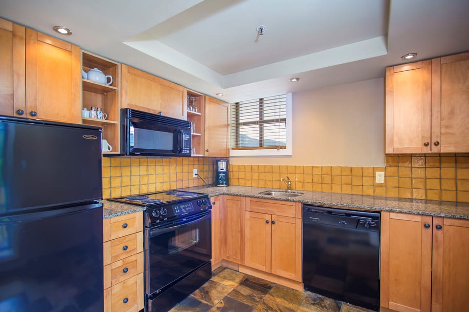 The gourmet kitchen comes fully-equipped for your convenience.