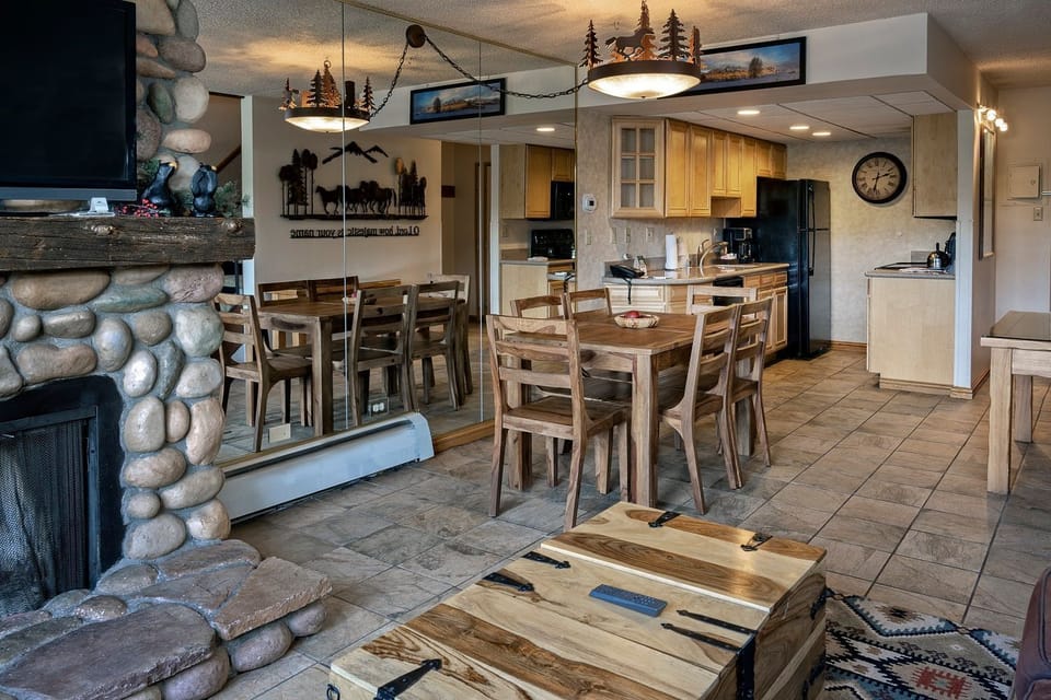 Gather around the fireplace in the inviting open-concept dining and living space.