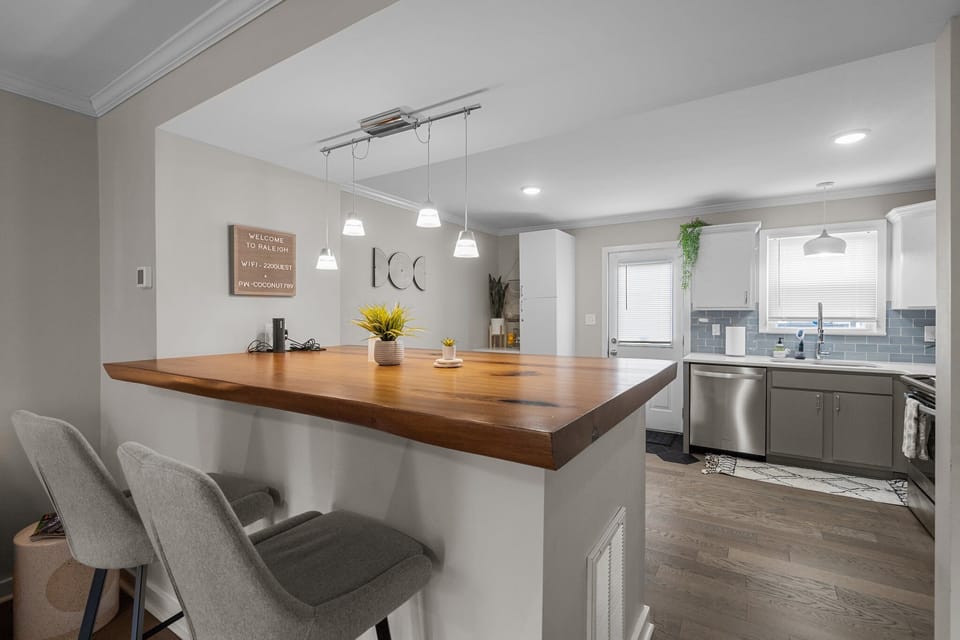 Extra large island made of natural hard wood slab with high gloss finish.