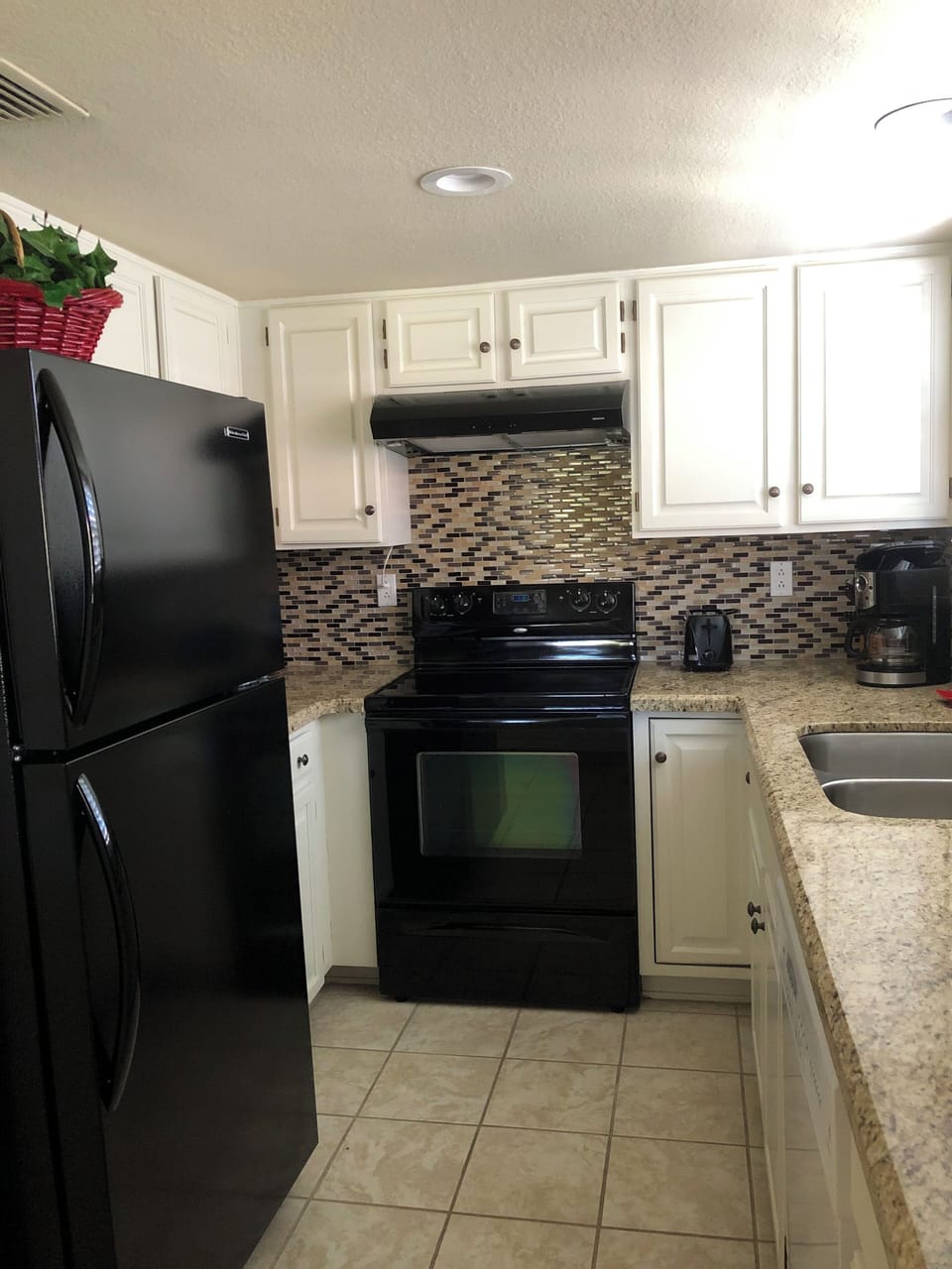 Cupboards & additional granite counter space on other side of refrigerator, too