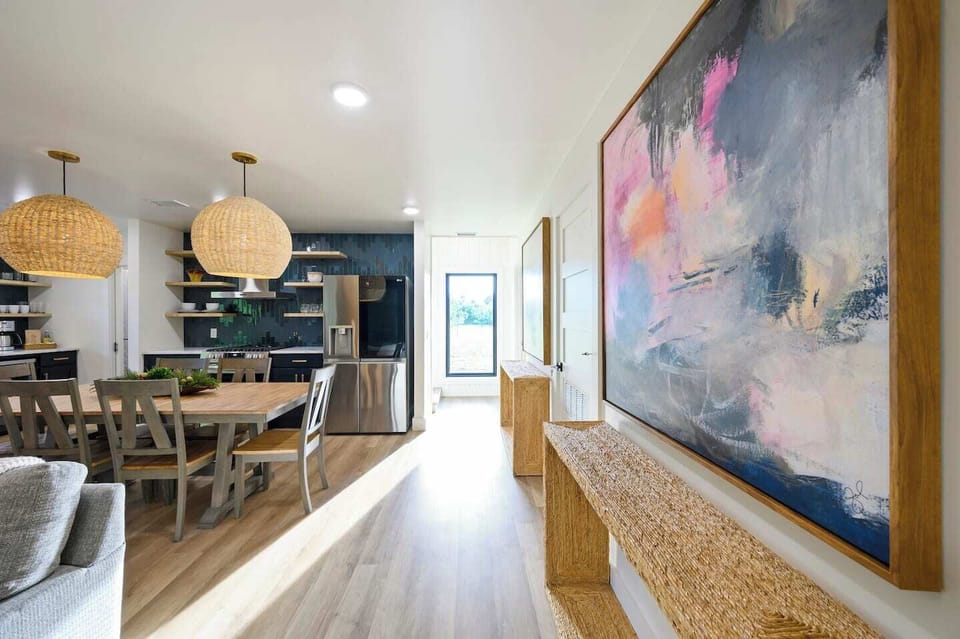 Enjoy the beautiful artwork and the stunning window view of the backyard, where nature provides a peaceful and picturesque backdrop. 