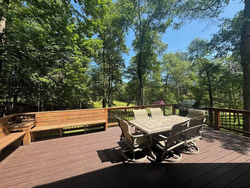 Large deck overlooking golf course w/ lots of seating & gas grill
