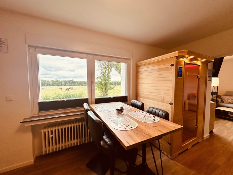 Dining area with sauna and view of the greenery