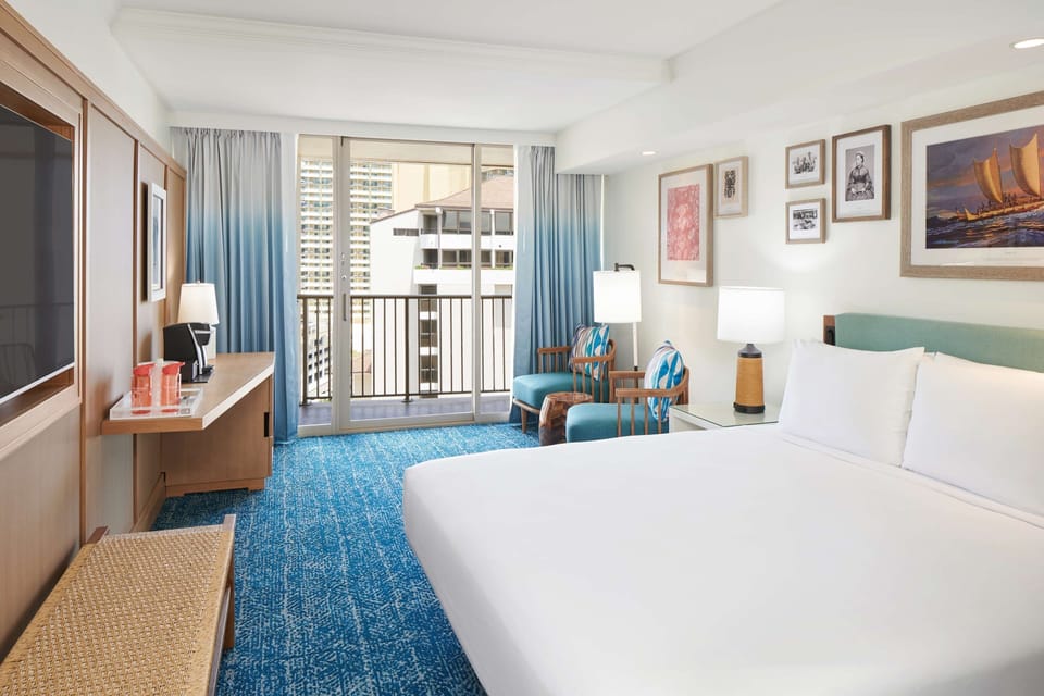 Recharge in a bright retreat with lounge seating and balcony.