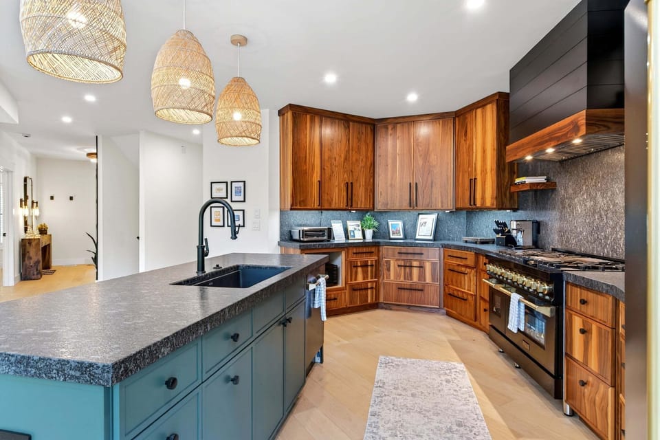 Kitchen with gas range, island, dishwasher, and multiple coffee options (standard drip-style, French press, and coffee grinder).