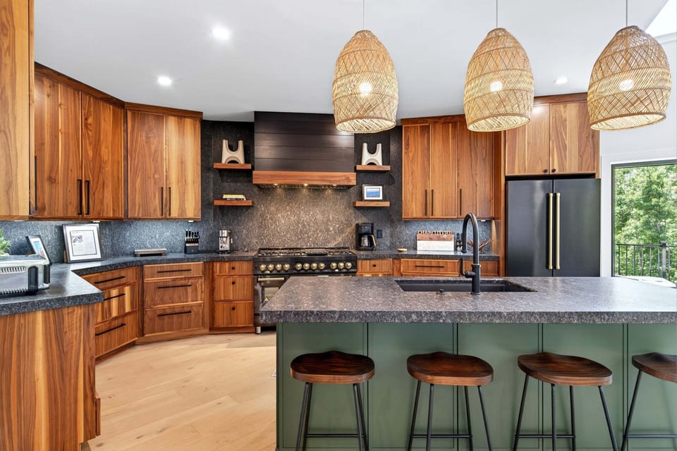 Kitchen with gas range, island, dishwasher, and multiple coffee options (standard drip-style, French press, and coffee grinder).