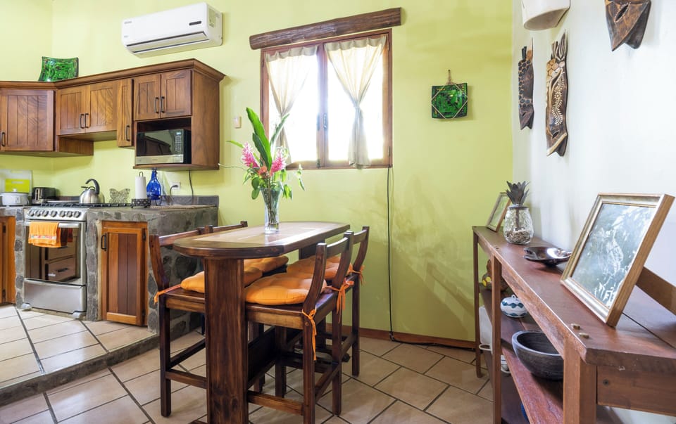 Open layout features a quaint four-seat dining area next to the kitchen.