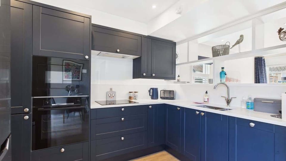 A modern kitchen fully equipped for self-catering, featuring an oven, microwave, and dishwasher.
