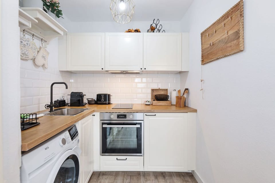 The soft, neutral palette paired with wood countertops creates a warm, welcoming kitchen ambiance.
