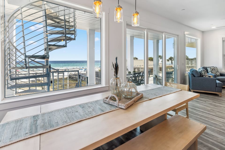 Watch the ocean waves from your elegant dining space, where floor-to-ceiling windows frame endless blue horizons and coastal charm.