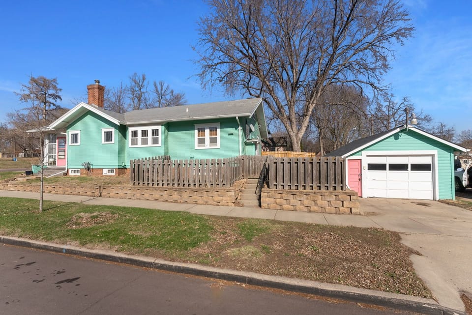 Guests can park along the street or in front of the garage, then enter up the steps and through the gate to the back patio.