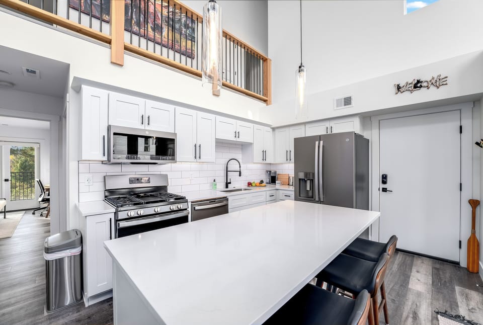 Stainless steel appliances include a gas range with a center griddle | Main Level